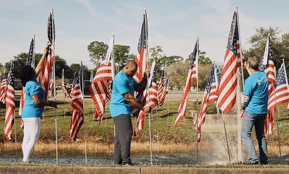Duke Energy volunteers help place flags at the Field of Honor in Seminole, Fla.