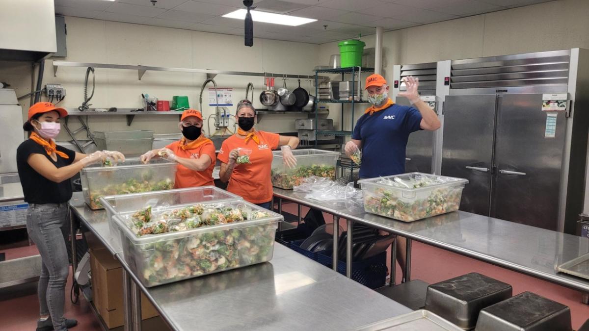 SAIC employees in San Diego, who are also members of the company's Equality Alliance Employee Resource Group, prep meals at Mama's Kitchen on  Sept. 15, 2022. 