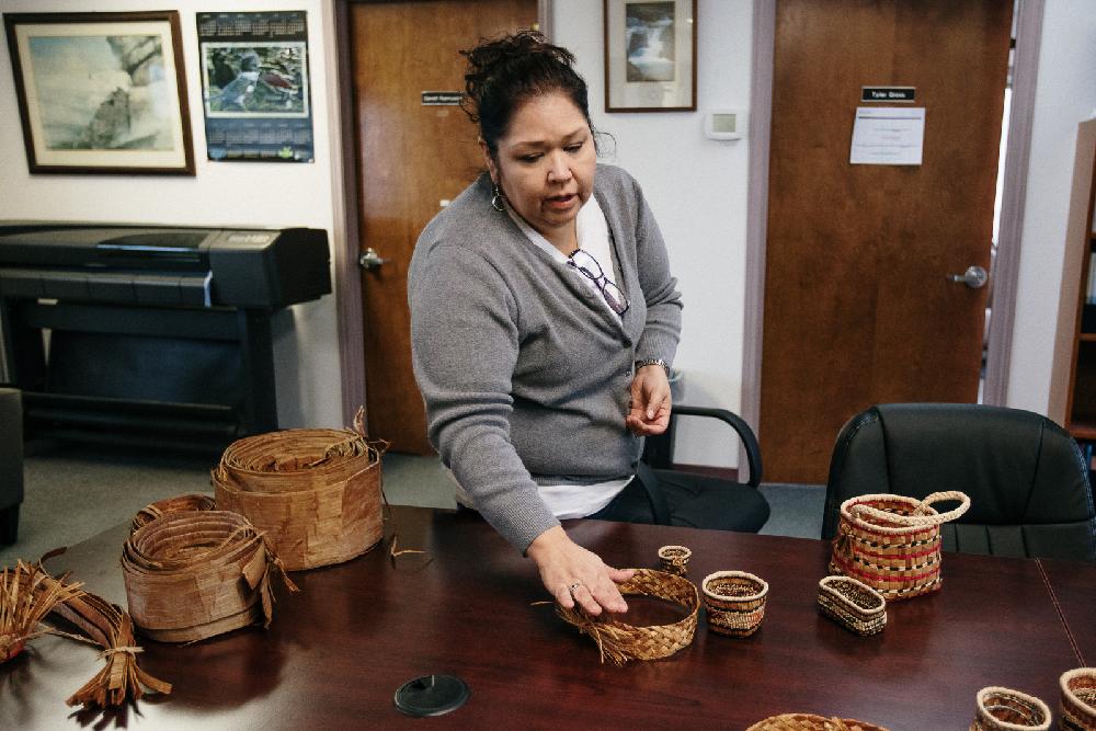Cathy Salazar displaying her woven baskets