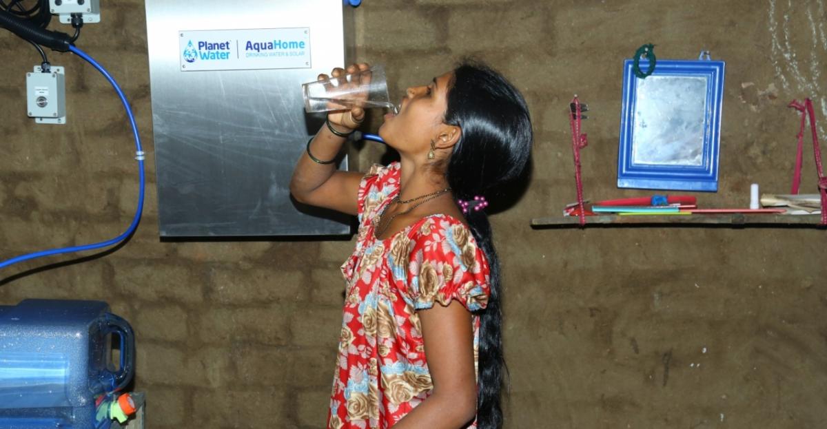 Woman drinking water from AquaHome