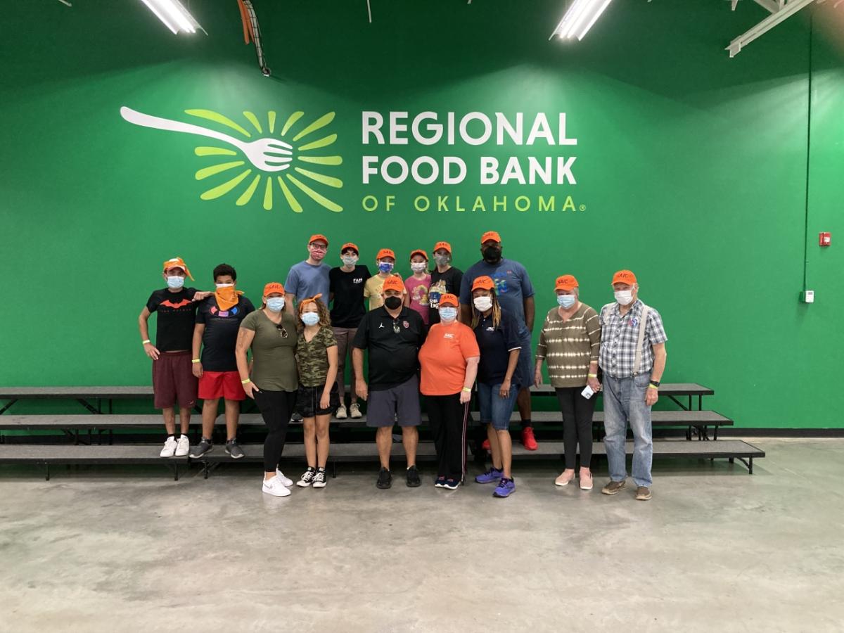 Oklahoma City employees take a timeout from preparing boxes of food and meals at the Regional Food Bank of Oklahoma on Sept. 17, 2022.