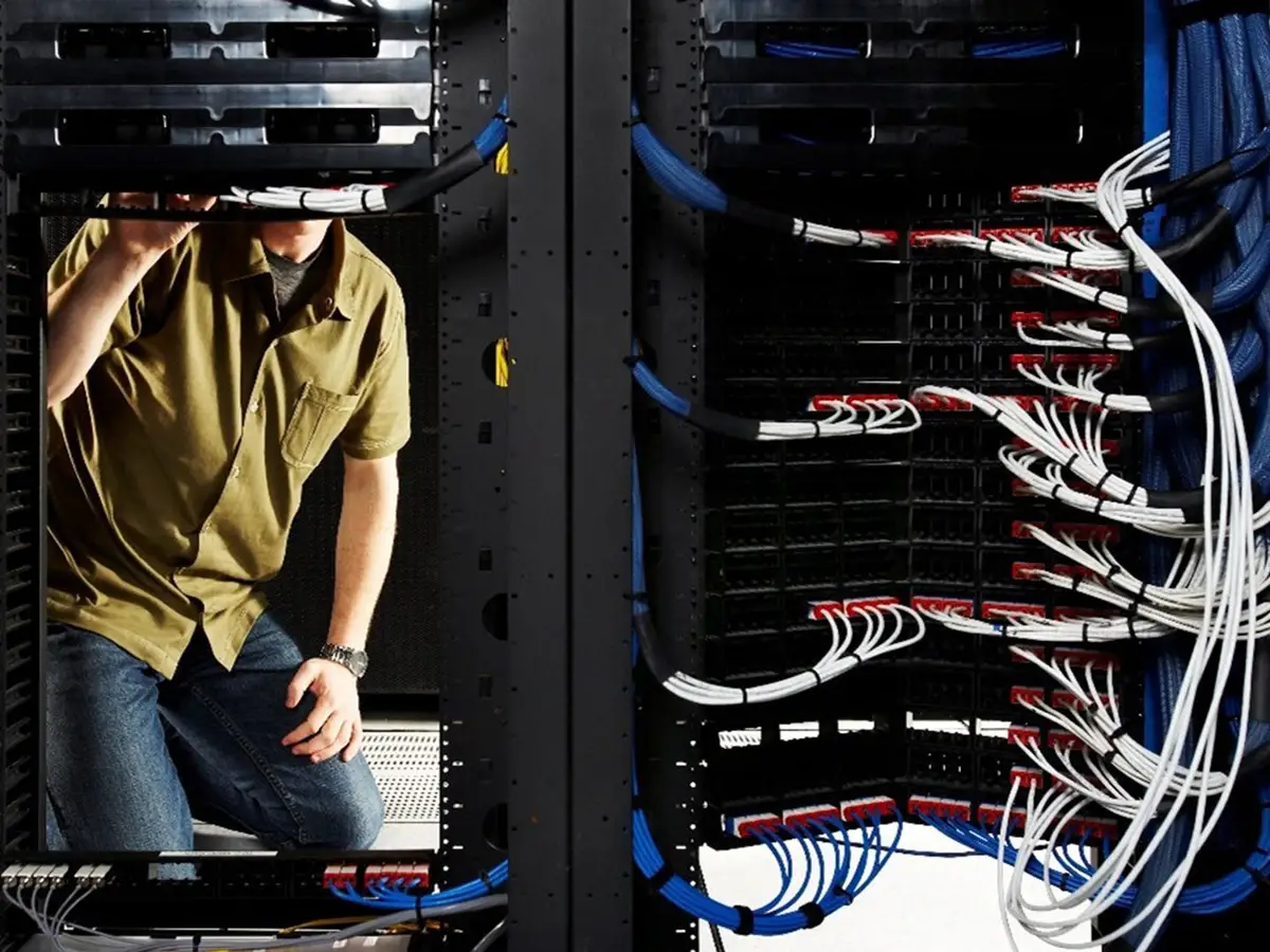 person in front of giant mainframe